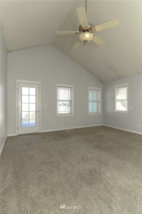 Spacious master bedroom with vaulted ceiling.