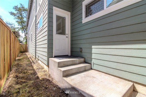 Backdoor entrance is within the fully fenced yard.