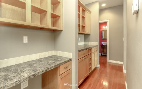 Butler's pantry with gorgeous cabinetry. Half bath with vanity and vessel sink. 