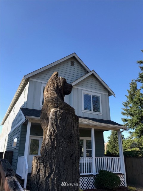 Two bears in a tree trunk welcome you home!