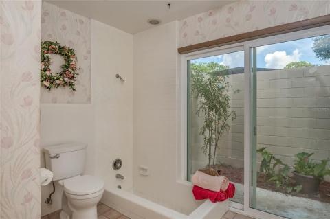 Spacious Master Bedroom with large walk in closets and sliding doors to the screened porch.