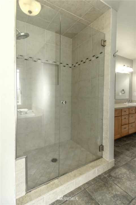 Huge low step shower and dual sink vanity in this five piece master bath.