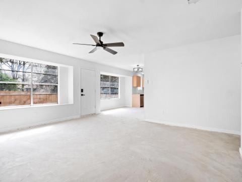 Unfurnished living room with baseboards, concrete