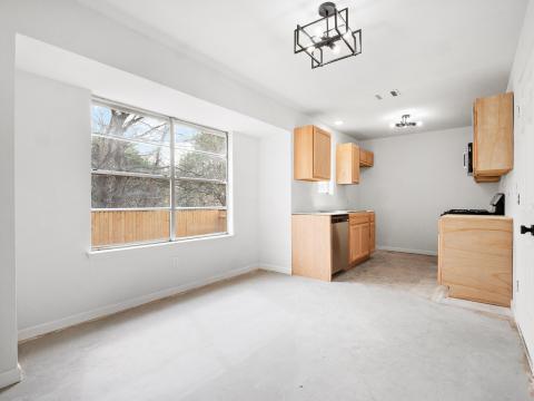 Kitchen with stainless steel dishwasher, light br