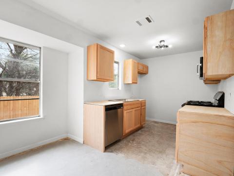 Kitchen featuring unfinished concrete floors, bas