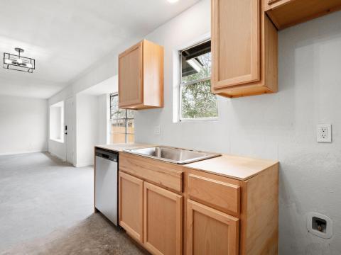 Kitchen with concrete floors, a sink, light brown