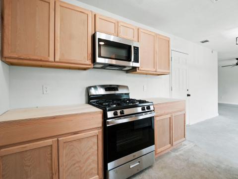 Kitchen featuring light countertops, light brown 