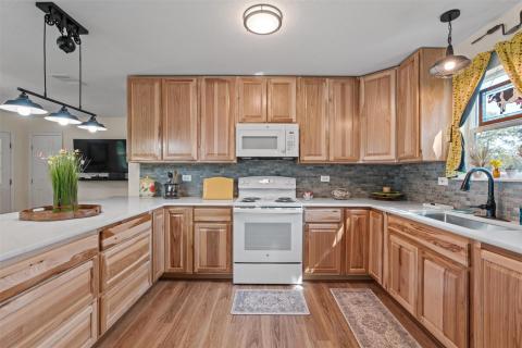 Kitchen with decorative light fixtures, white app