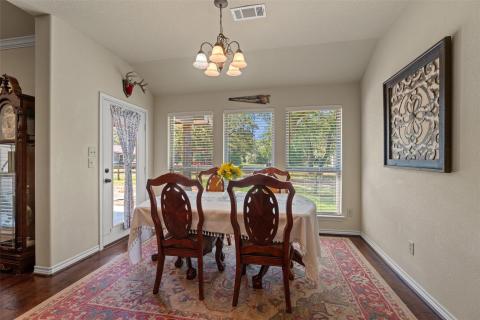 Dining area featuring vaulted ceiling, dark wood-