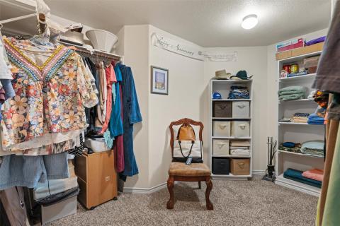 Spacious closet with light colored carpet