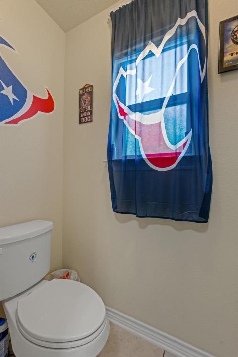 Bathroom featuring baseboards and toilet