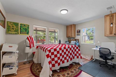 Bedroom featuring light wood-style floors, an off