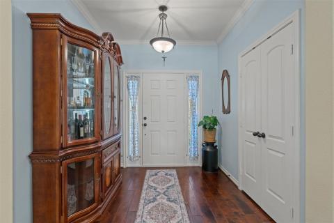 Foyer entrance with dark wood-style floors and or