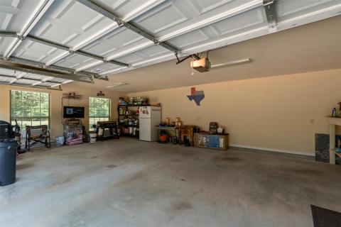 Garage with freestanding refrigerator and a garag