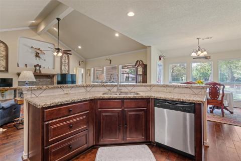 Kitchen featuring open floor plan, dark wood-styl