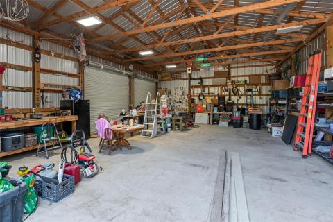 Garage featuring a workshop area and metal wall