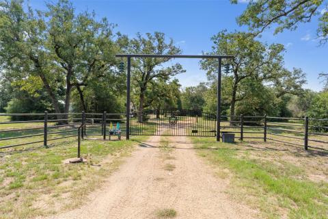 View of dirt / gravel road with a gate