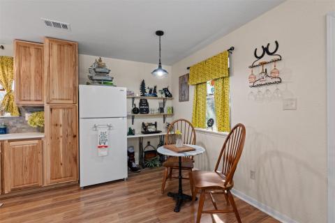 Kitchen featuring freestanding refrigerator, ligh