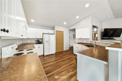 Kitchen is bright and airy. Plenty of cabinets, along with a pantry. 