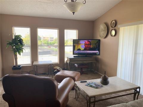 Living room overlooking Bradenton Tennis Center and Sarasota Bay with partial bay views. Balcony on right shown in first photo. Lanai is to left in this photo.
