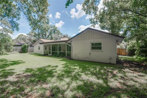Family room has two sliders leading to screened porch an a wood burning fireplace. Soaring ceilings and hardwood flooring.
