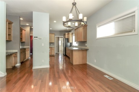 Kitchen has breakfast bar and opens to the dining room and living room.