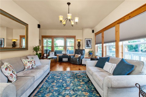 Another view of main living space looking out toward covered main entrance on wrap-around deck. Another view of main living space looking out toward covered main entrance on wrap-around deck.