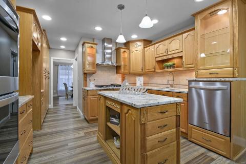 Plenty of custom cabinets, granite counters, stainless steel appliances, gas stove, double oven