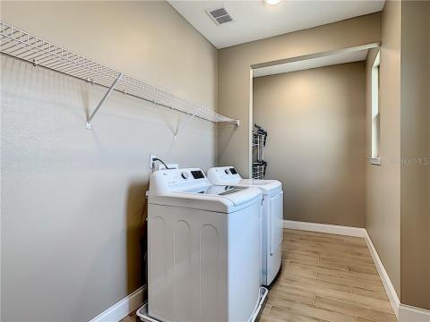 Full-size indoor laundry room with plenty of storage space