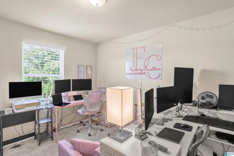 Carpeted interior room with neutral wall paint and a single window featuring white blinds