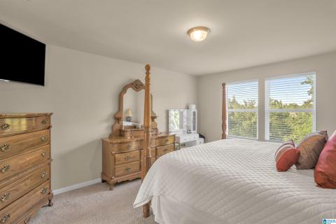 Room featuring two windows with horizontal blinds, neutral wall paint, and light-toned carpet flooring
